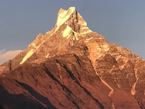 Golden sunset over Fishtail Mountain during the Mardi Himal Trek.