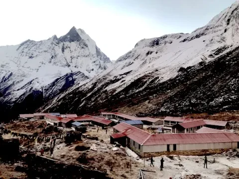 Mountain lodges at Annapurna Base Camp with Mount Fishtail Machhapuchhre in the background.