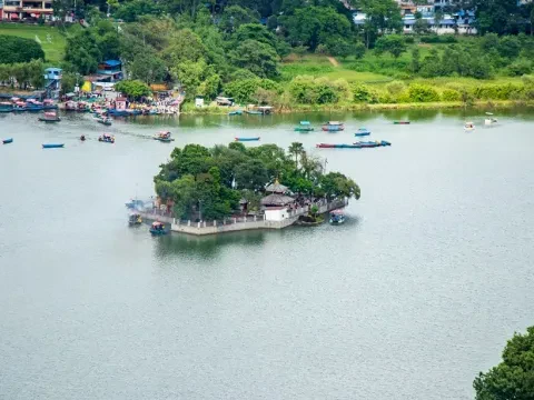 Phewa Lake in Pokhara with peaceful waters and Himalayan mountain views in Nepal.