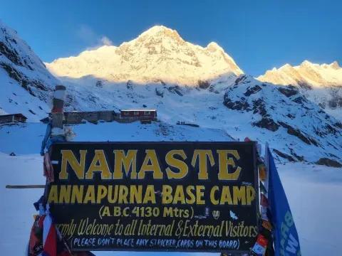 Snow-covered Annapurna Base Camp surrounded by Himalayan peaks in winter, Nepal.