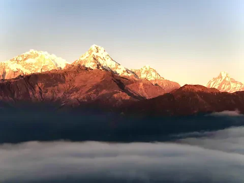 Golden sunrise illuminating Annapurna South in the Himalayas of Nepal.