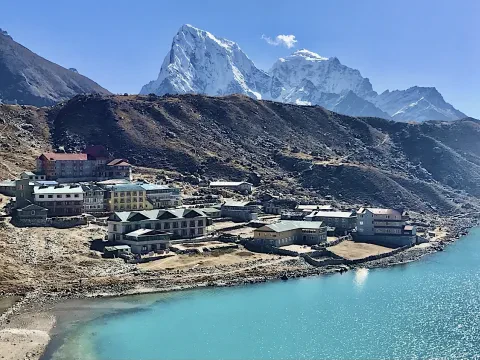 Gokyo Lake surrounded by snow-capped Himalayan mountains in Nepal.