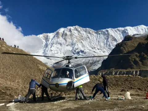 Helicopter landed at Annapurna Base Camp to pick up passengers for a flight to Pokhara.