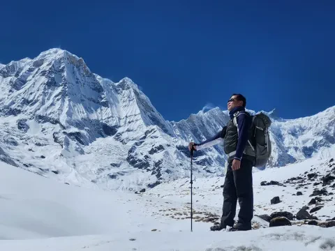 Trekkers heading to Annapurna Base Camp through a snowy Himalayan trail in Nepal.
