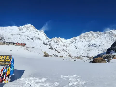 Snow-covered Annapurna Base Camp surrounded by towering Himalayan peaks in Nepal.