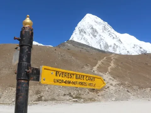 Everest Base Camp trail marker sign pointing the way to Everest Base Camp in Nepal.