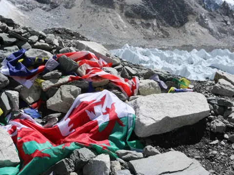 Everest Base Camp with colorful prayer flags and Himalayan peaks, Nepal.