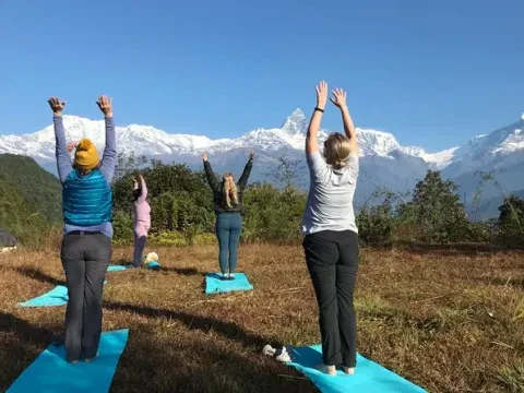 Yoga practice at Australian Camp in Nepal with stunning Himalayan mountain range views.