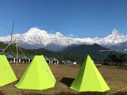 Camping tent and mountain lodge at Australian Camp with stunning views of the Annapurna Himalayan range in Nepal.
