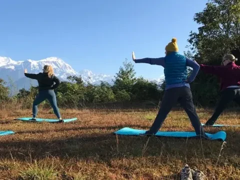 Yoga practice in Sarangkot, Pokhara, with stunning panoramic views of the Annapurna Himalayan range.