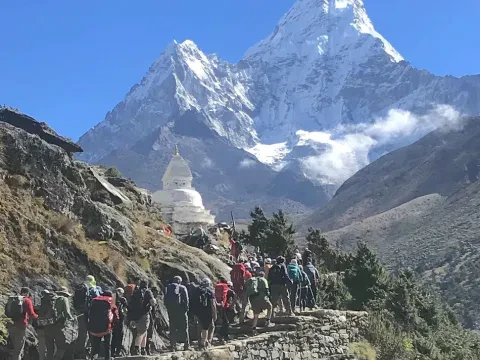 Trekkers heading toward Everest Base Camp with Mount Ama Dablam in view, Nepal.