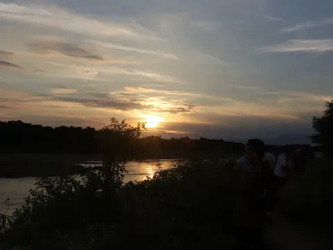 Golden sunset over the Rapti River in Chitwan National Park, Nepal, with colourful evening skies.