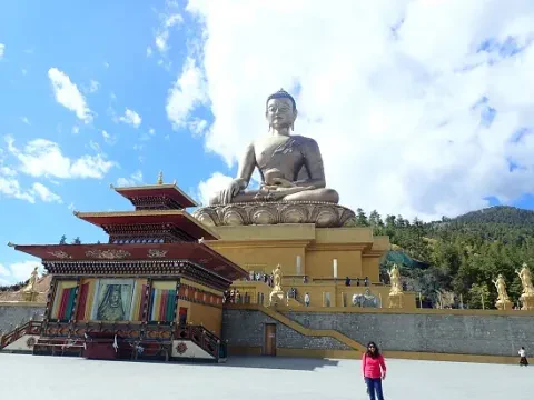 Buddha stupa in Bhutan surrounded by peaceful Himalayan scenery.