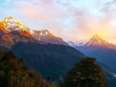 Golden rays illuminating Annapurna and Machhapuchhre from Tadapani.