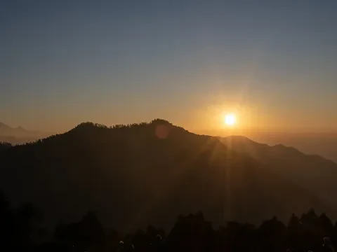Golden sunlight over the mountain valley from Poon Hill.