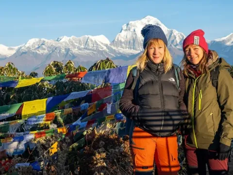 Trekkers at Poon Hill viewpoint with the Dhaulagiri mountain range.