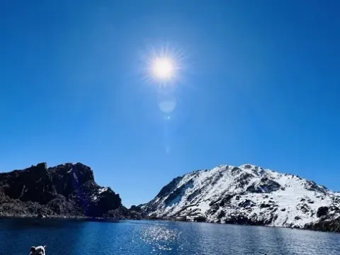 Gosainkunda Lake with snow-covered Himalayan peaks.