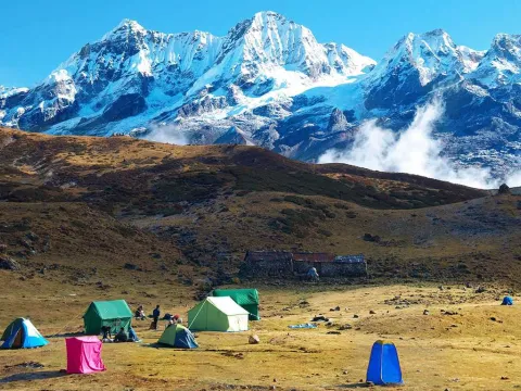 Trekking tents set up at Kanchenjunga South Base Camp beneath the Himalayan peaks.