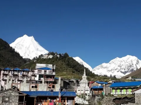 Lho village and monastery with Mount Manaslu in the background.