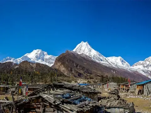 Syala village surrounded by Himalayan mountains on the Manaslu Circuit Trek.