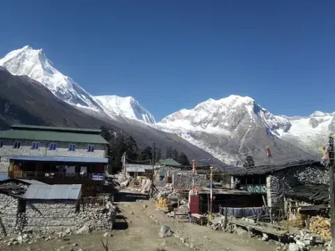 Syala village surrounded by Himalayan mountains on the Manaslu Circuit Trek.