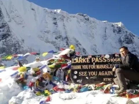 Larke Pass surrounded by snow-covered Himalayan mountains on the Manaslu Circuit Trek.