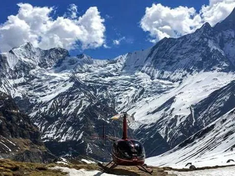 Helicopter landed at Annapurna Base Camp surrounded by mountains.