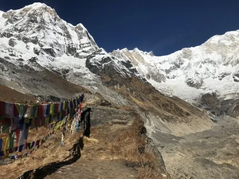 Guests exploring Annapurna Base Camp surrounded by Himalayan mountains .