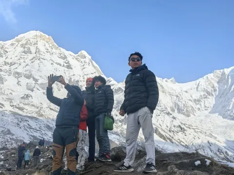 Exploring Annapurna Base Camp beneath snow-capped mountains.