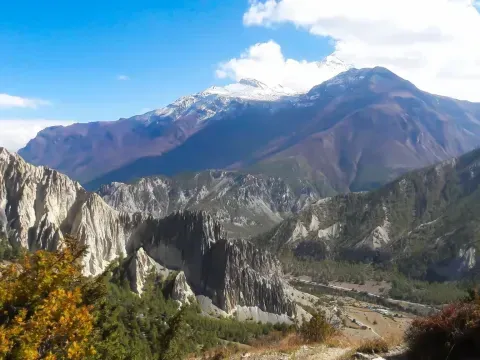 Alpine landscape of Manang Valley with rugged mountains and high-altitude terrain on the Annapurna Circuit Trek Caption: Scenic alpine landscape of Manang Valley surrounded by rugged Himalayan mountains along the Annapurna Circuit Trek.