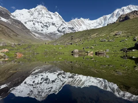 Annapurna mountains reflected in a lake along the trail to Annapurna Base Camp in Nepal.