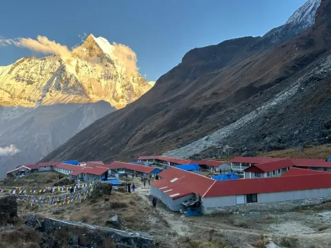 Annapurna Base Camp with golden sunset light on Machhapuchhre Fishtail Mountain in Nepal.
