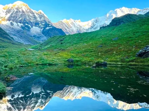 Annapurna mountains reflected in a clear lake along the Annapurna Base Camp Trek in Nepal.