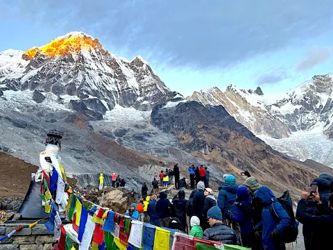 Trekkers enjoying the panoramic mountain views from Annapurna Base Camp viewpoint in Nepal.