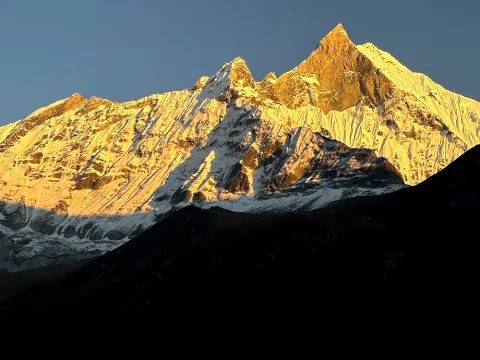 Golden sunset over Mount Fishtail (Machhapuchhre) during the Annapurna Base Camp Trek in Nepal.