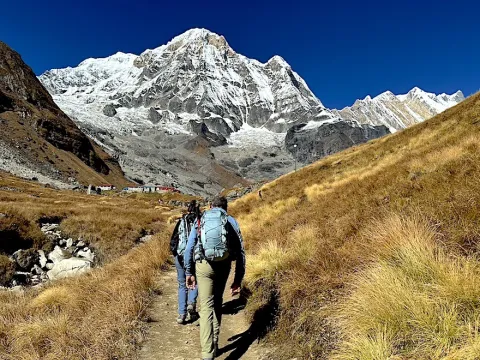 Trekkers heading toward Annapurna Base Camp through the scenic Himalayan landscape of Nepal.