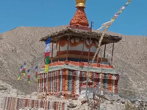 Traditional Buddhist stupa surrounded by the rugged landscape of Upper Mustang, Nepal.