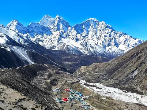 Pheriche village surrounded by Himalayan mountains in the Everest region of Nepal .