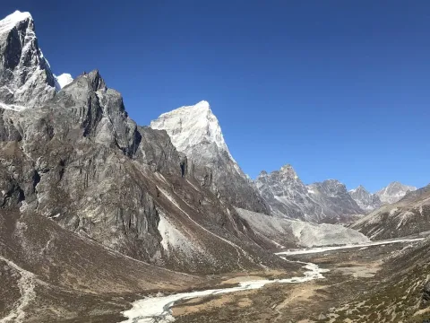 Alpine landscape of Pheriche Valley surrounded by towering Himalayan mountains in Nepal.