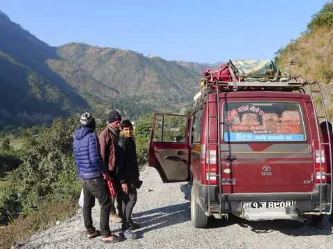 Jeep driving on a mountain road toward the Everest Base Camp trekking route in Nepal.
