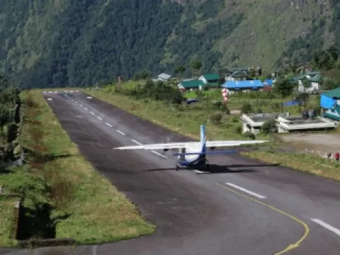 Lukla Airport in the Everest region of Nepal with mountains in the background.