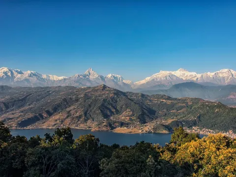 Scenic view of Phewa Lake in Pokhara with the snow-capped Himalayan mountain ranges in the background, Nepal.