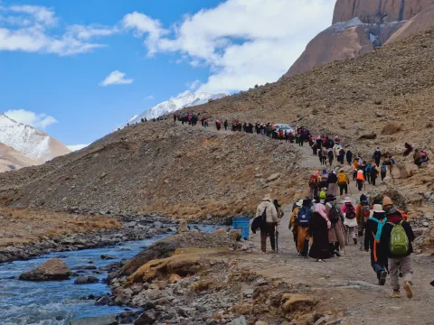 Pilgrims trekking the sacred Kailash Kora route in Tibet.