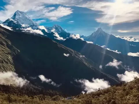 Dramatic sun rays shining through Himalayan mountains in Nepal.