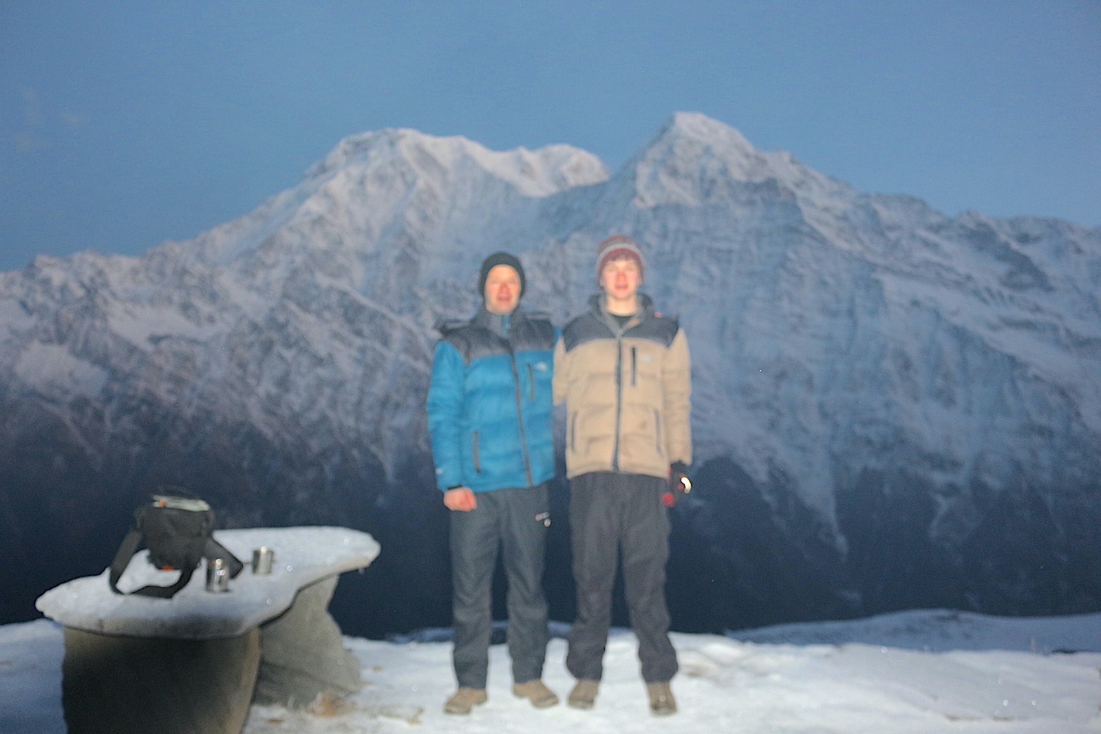 Trekkers wearing warm clothing and insulated gear in cold high-altitude conditions on a Himalayan trek in Nepal.