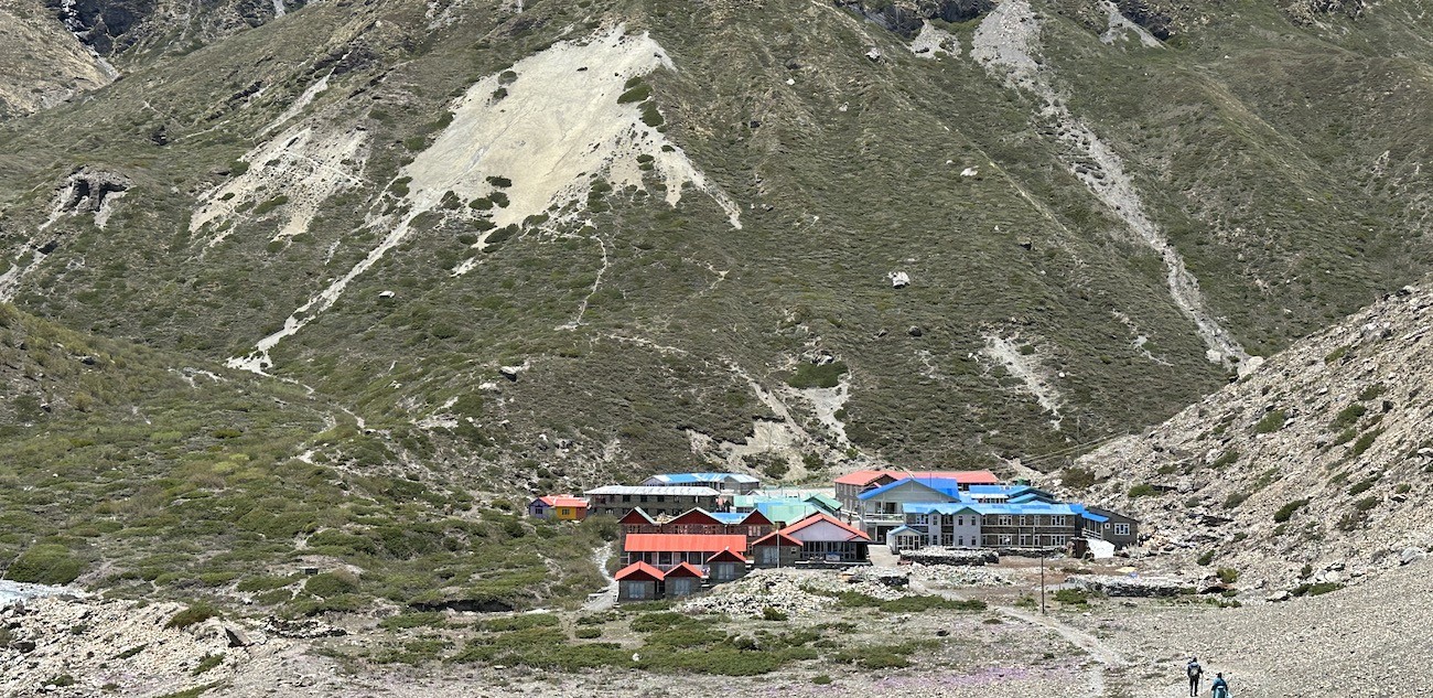  Tilicho Base Camp with mountain lodges and snow-covered Himalayan peaks in the Annapurna region of Nepal.