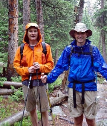 Waterproof rain gear, including a rain jacket, rain pants, backpack rain cover, and waterproof hiking boots, worn by trekkers on the Manaslu Circuit Trek.