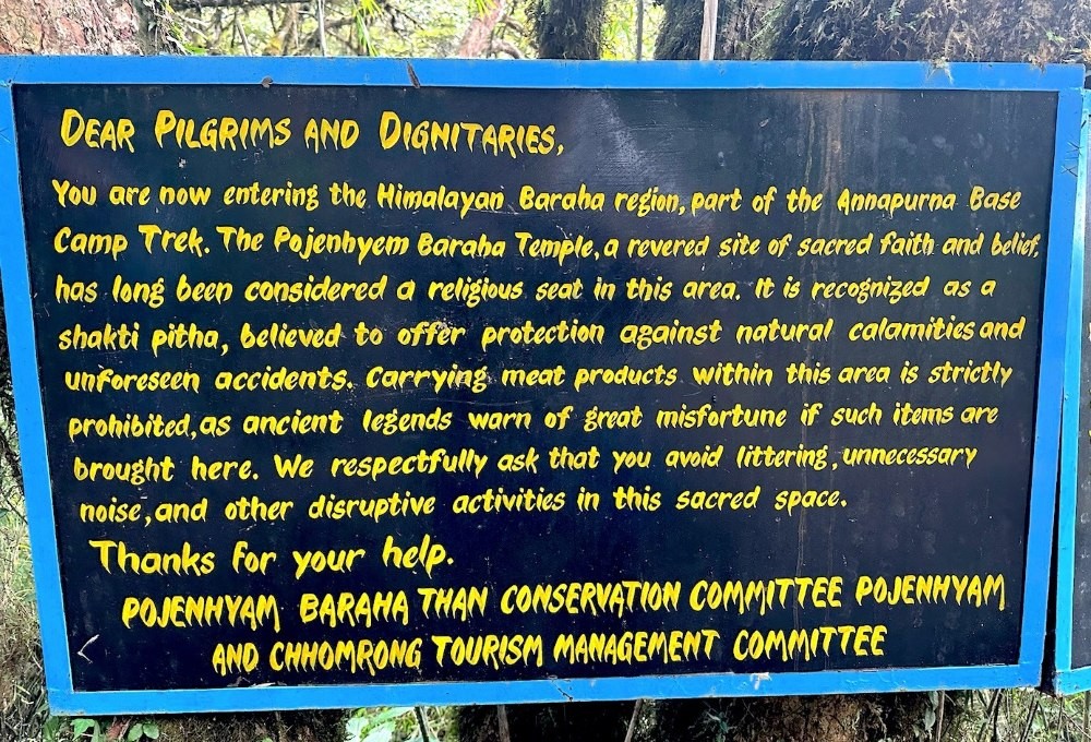 Notice board at a sacred temple site in Nepal displaying rules for visitors, with signage about respectful behavior, and cultural guideline