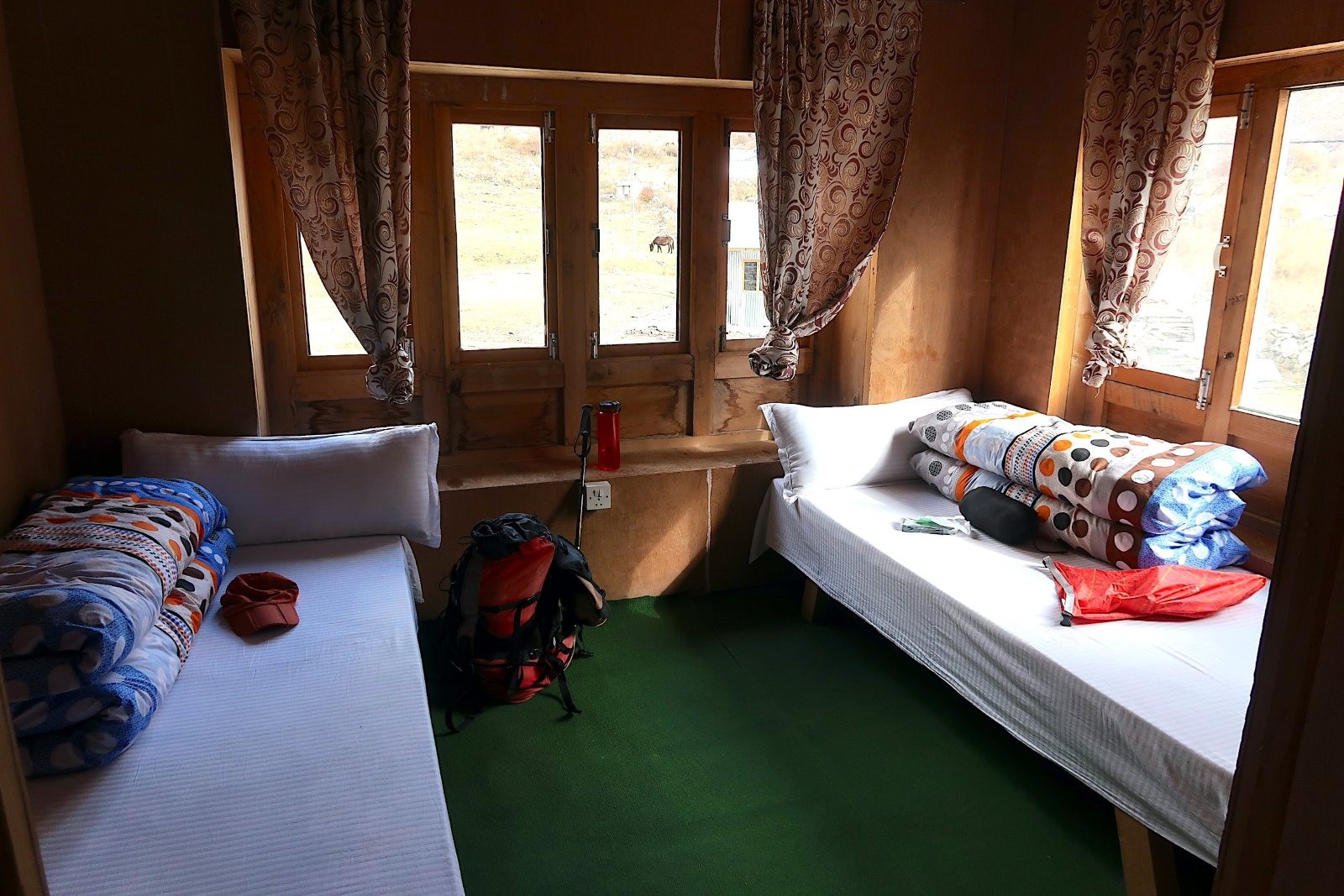 Simple mountain room with twin beds in a Manaslu teahouse