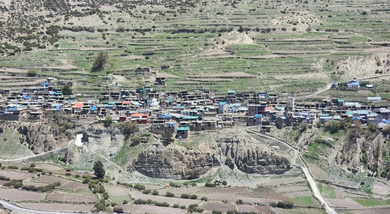 Traditional Manang Village surrounded by snow-capped Annapurna peaks, stone-built houses, ancient monasteries, colorful prayer flags, and dramatic Himalayan landscapes on the Annapurna Circuit Trek in Nepal.